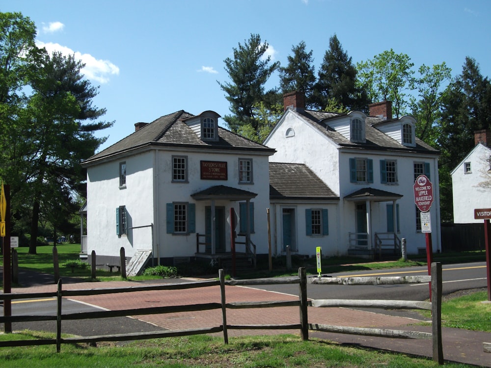 a white house with a fence around it