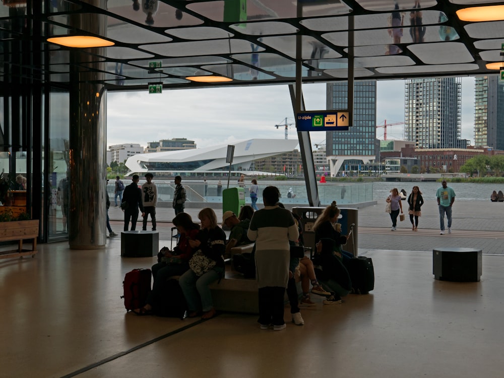 a group of people sitting on a bench in a building