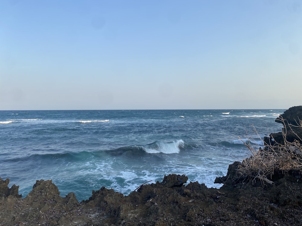 a view of the ocean from a rocky cliff