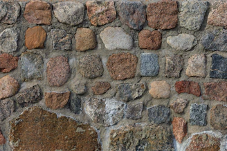 Finished masonry wall with a rustic texture and natural color tones.