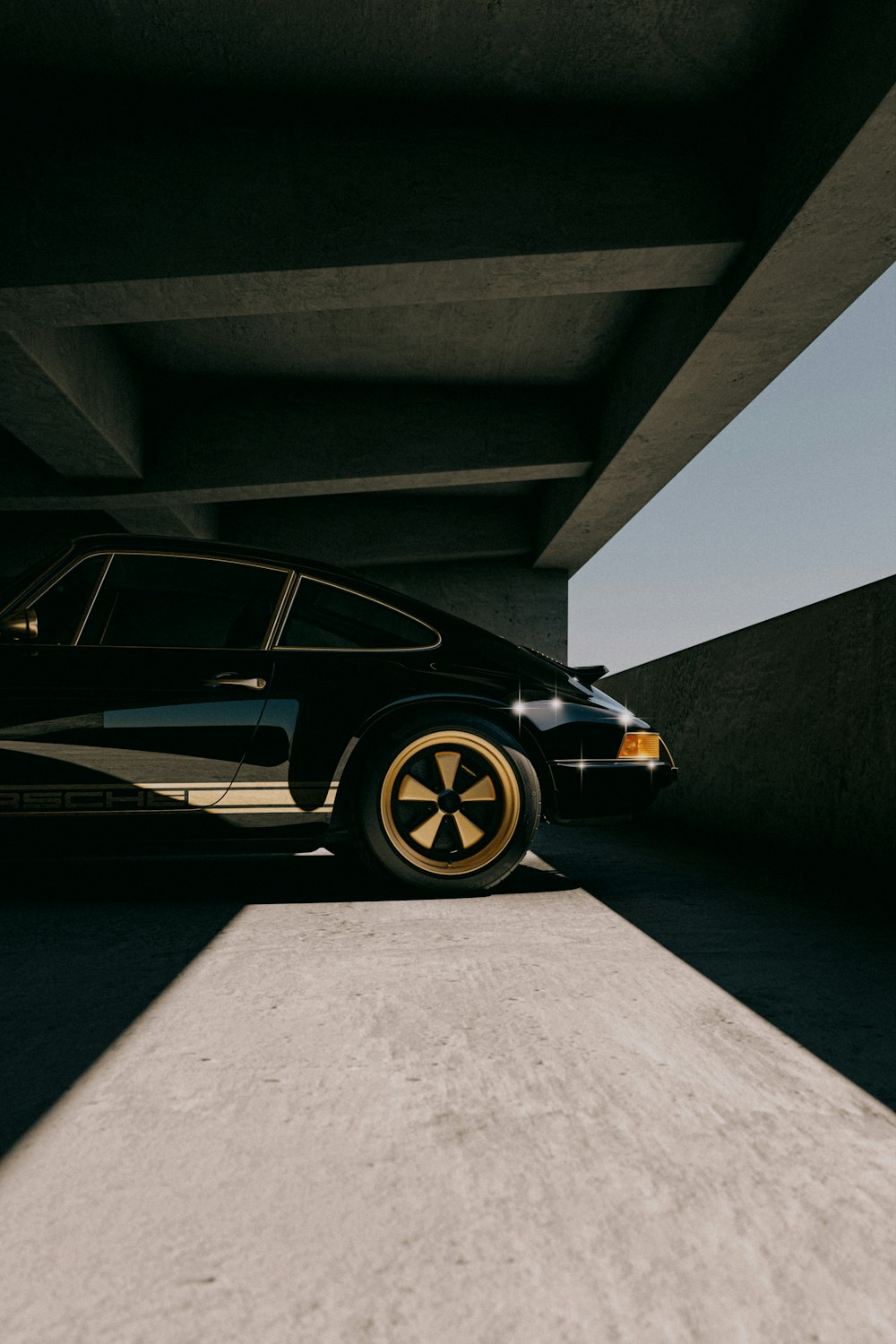 a black car parked in a parking garage