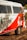 A vintage van painted in white and red with cactus and sun designs on the side. The text 'Instituto Céu No Sertão' is visible, along with Instagram handle details and a message in Portuguese. The van is located outdoors with foliage partially shading it.