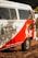 A vintage van painted in white and red with cactus and sun designs on the side. The text 'Instituto Céu No Sertão' is visible, along with Instagram handle details and a message in Portuguese. The van is located outdoors with foliage partially shading it.