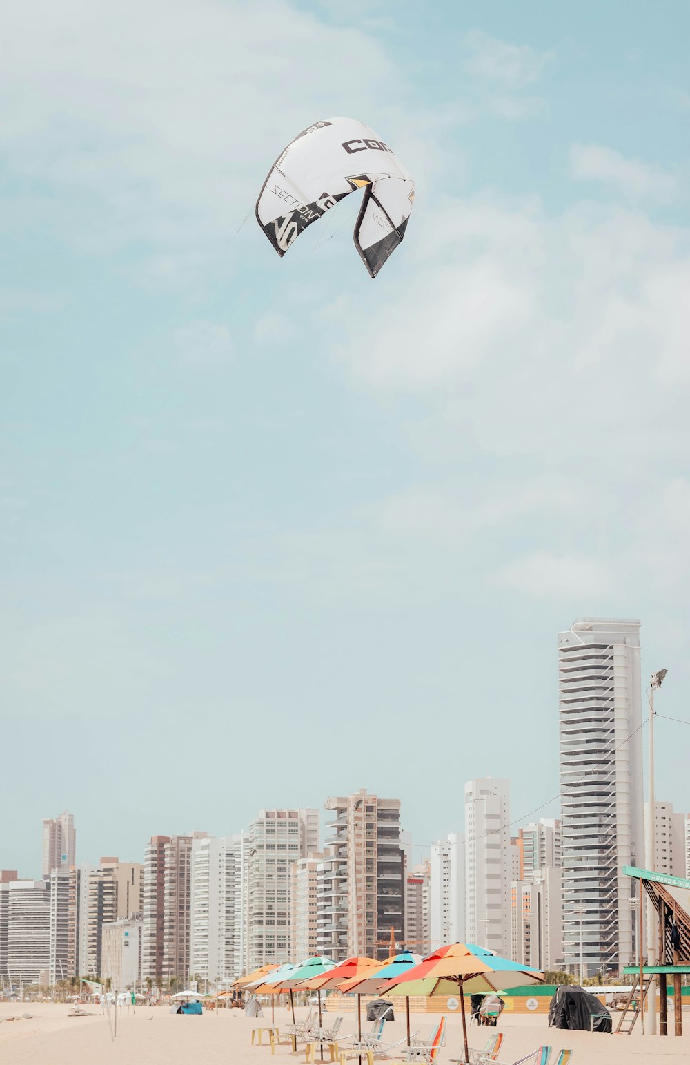 a person flying a kite on the beach