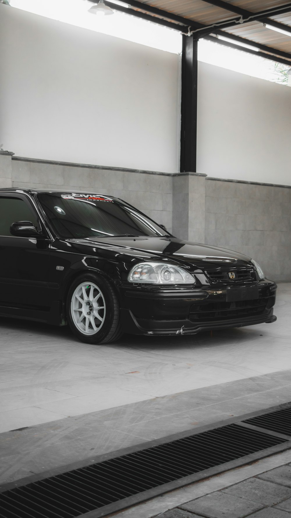 a black car parked in a parking garage