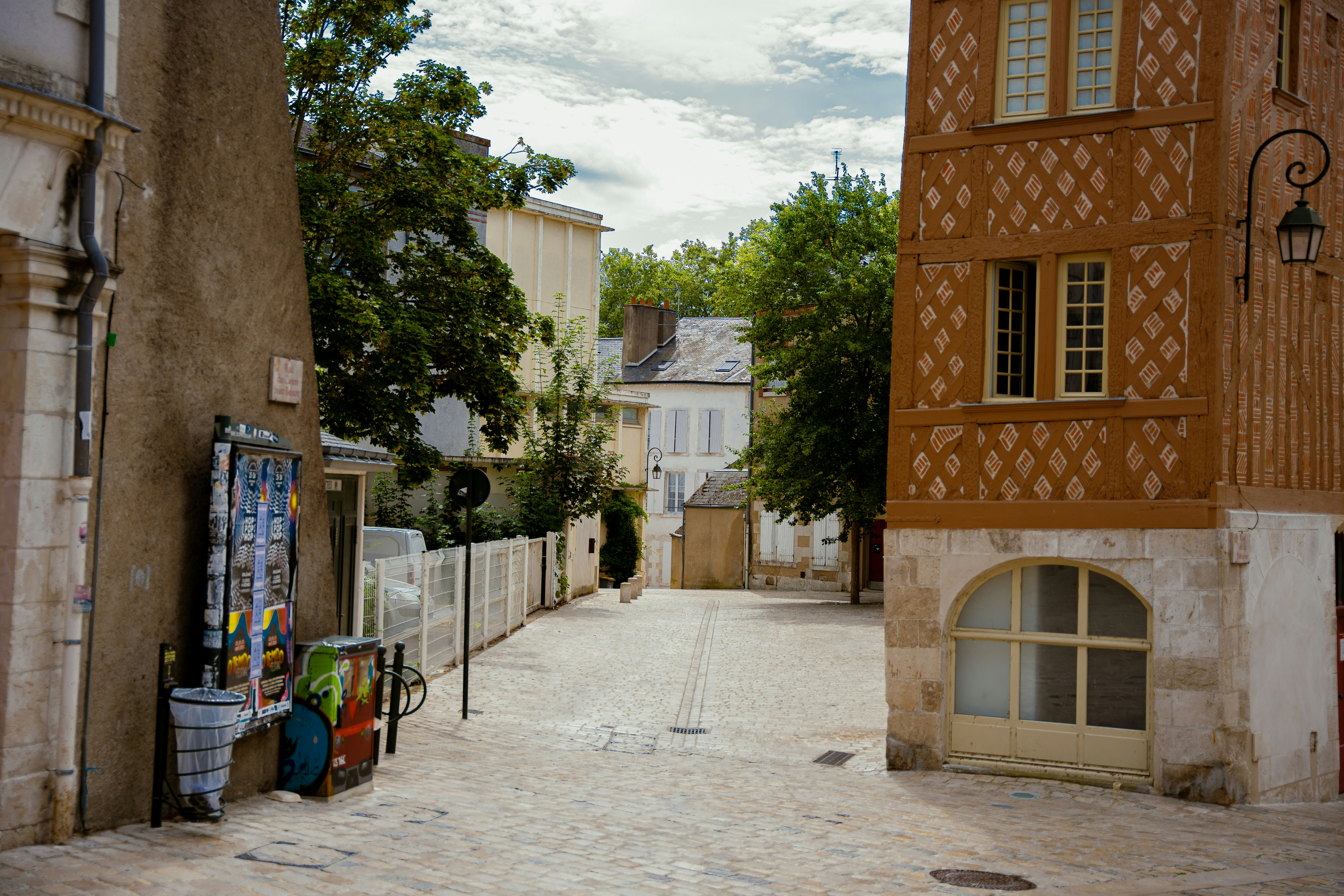 a narrow street with a tall building in the background