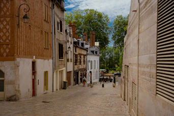 Historic European street with cobblestones and cozy cafes