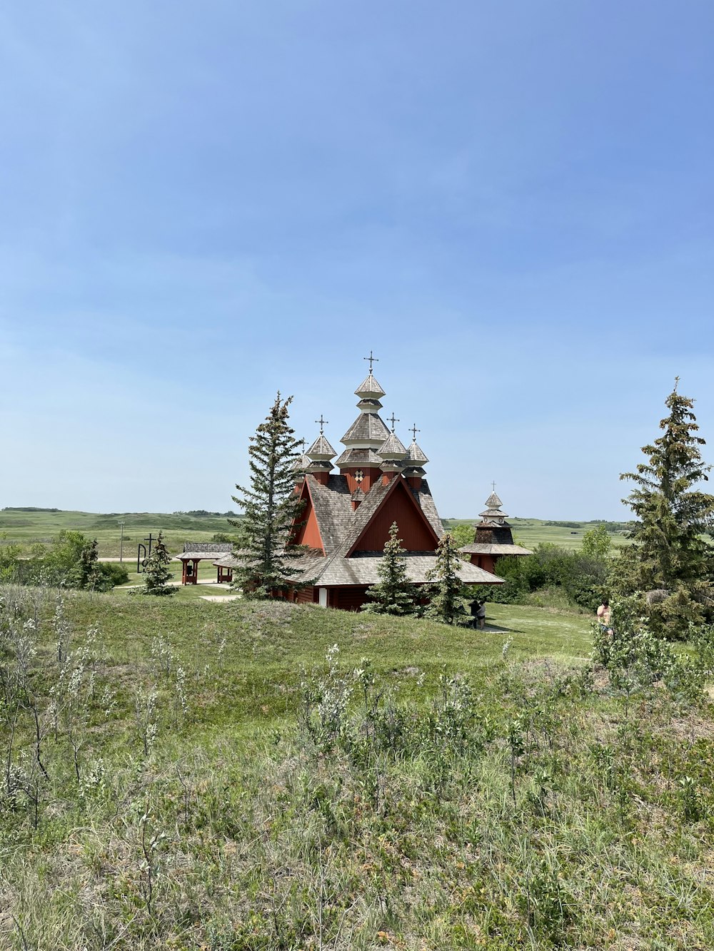 a church in the middle of a grassy field