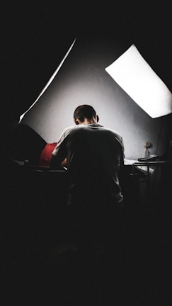 A portrait of a team member focused on their work at a bright desk.