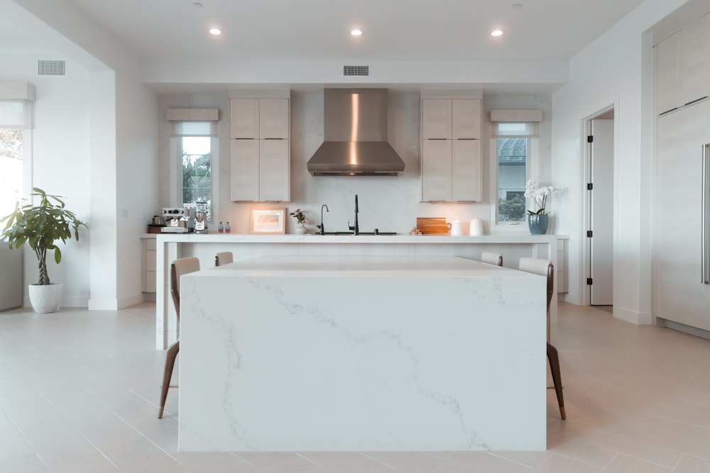 a kitchen with a marble counter top and white cabinets