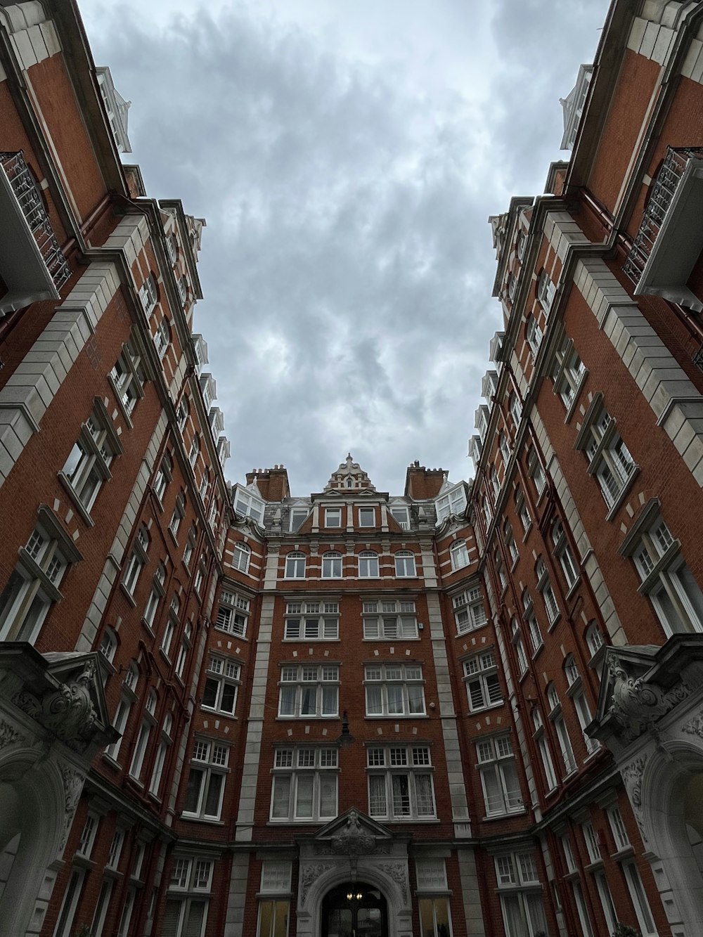 a very tall building with many windows and a sky background