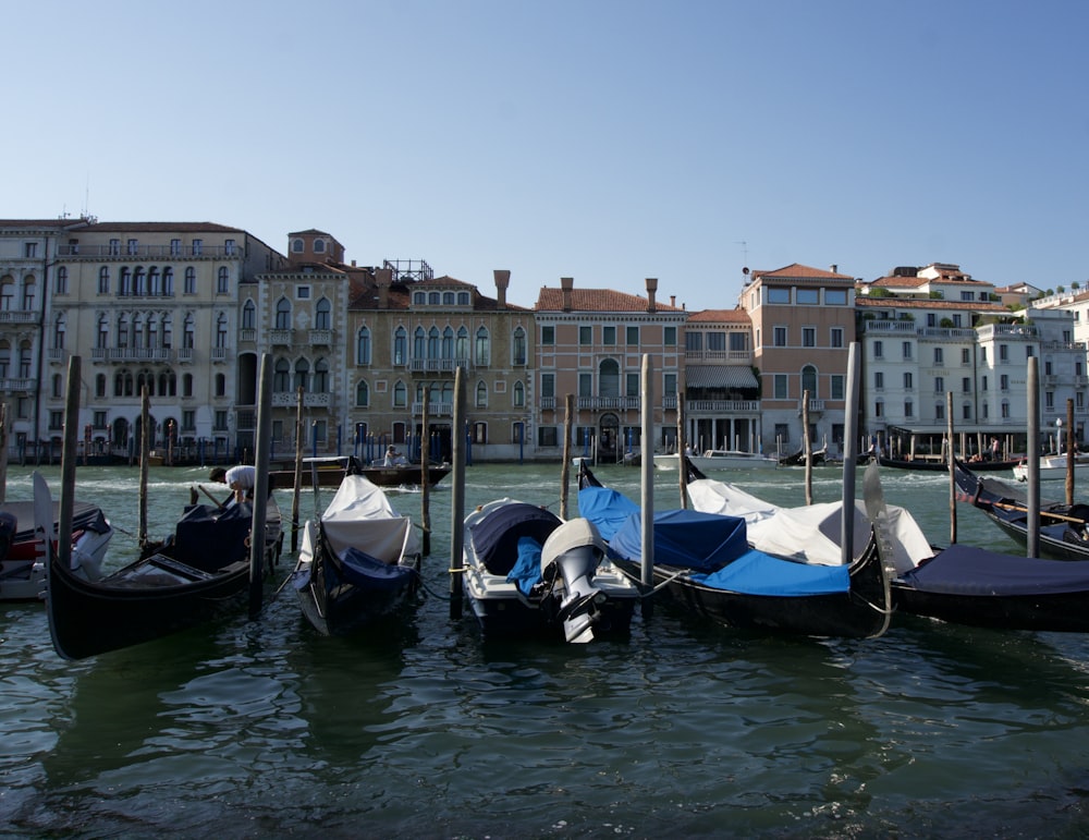 a row of gondolas sitting next to a row of buildings