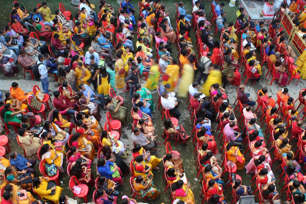 a crowd of people standing around each other