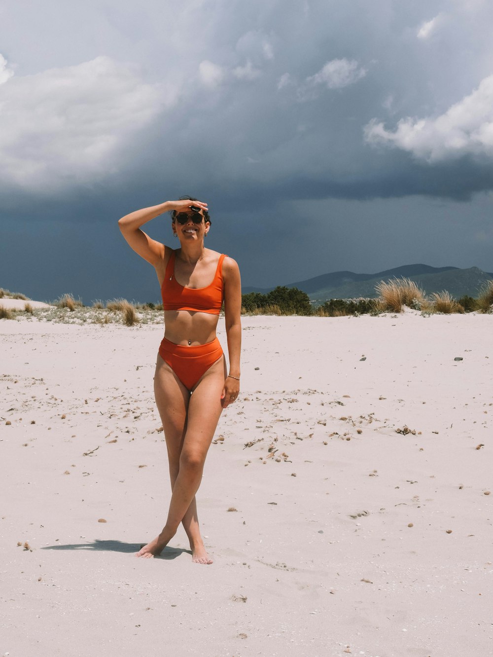 a woman in a bikini standing on a beach