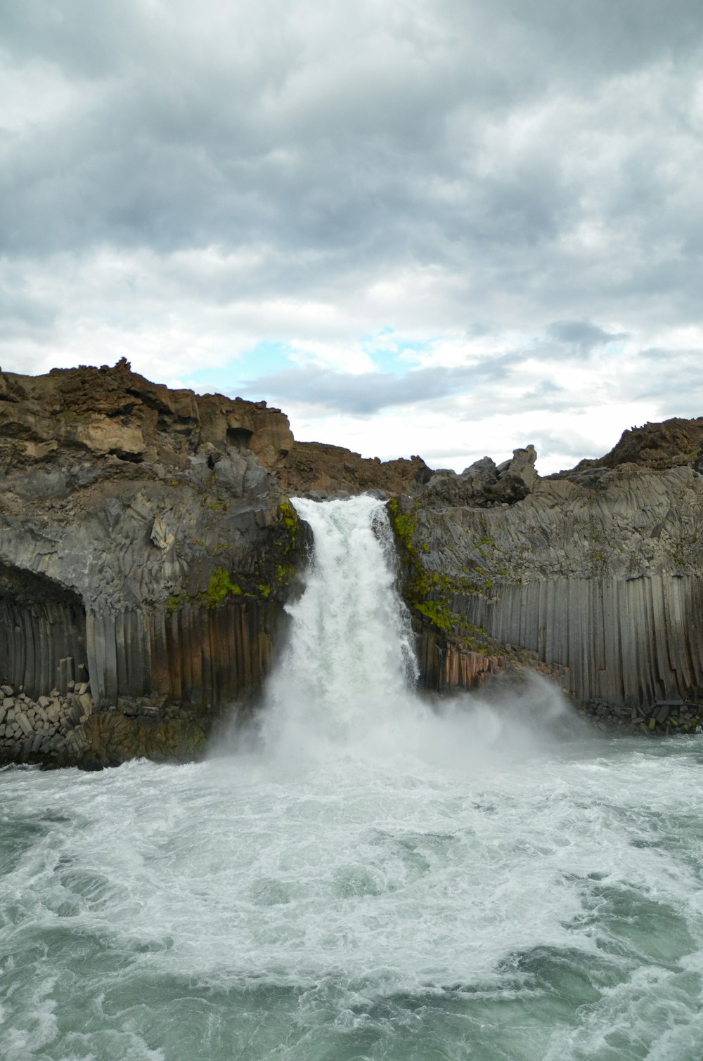 a large waterfall is coming out of a large body of water