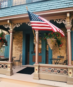 A cozy front porch with custom woodwork and vibrant flower beds.