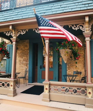 A welcoming front porch of a cozy Missouri rest home surrounded by blooming flowers.