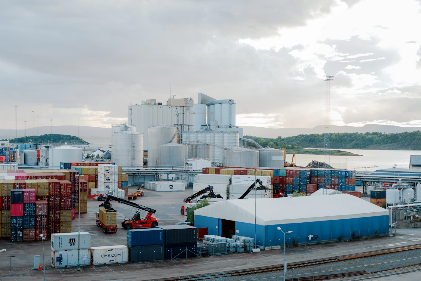 A sprawling industrial port area beside open water, representing the navigable waters and adjoining areas covered by the LHWCA situs test