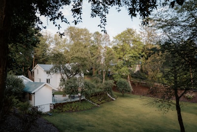 A serene gated farmland community with lush green plantations and well-laid pathways under a clear blue sky.