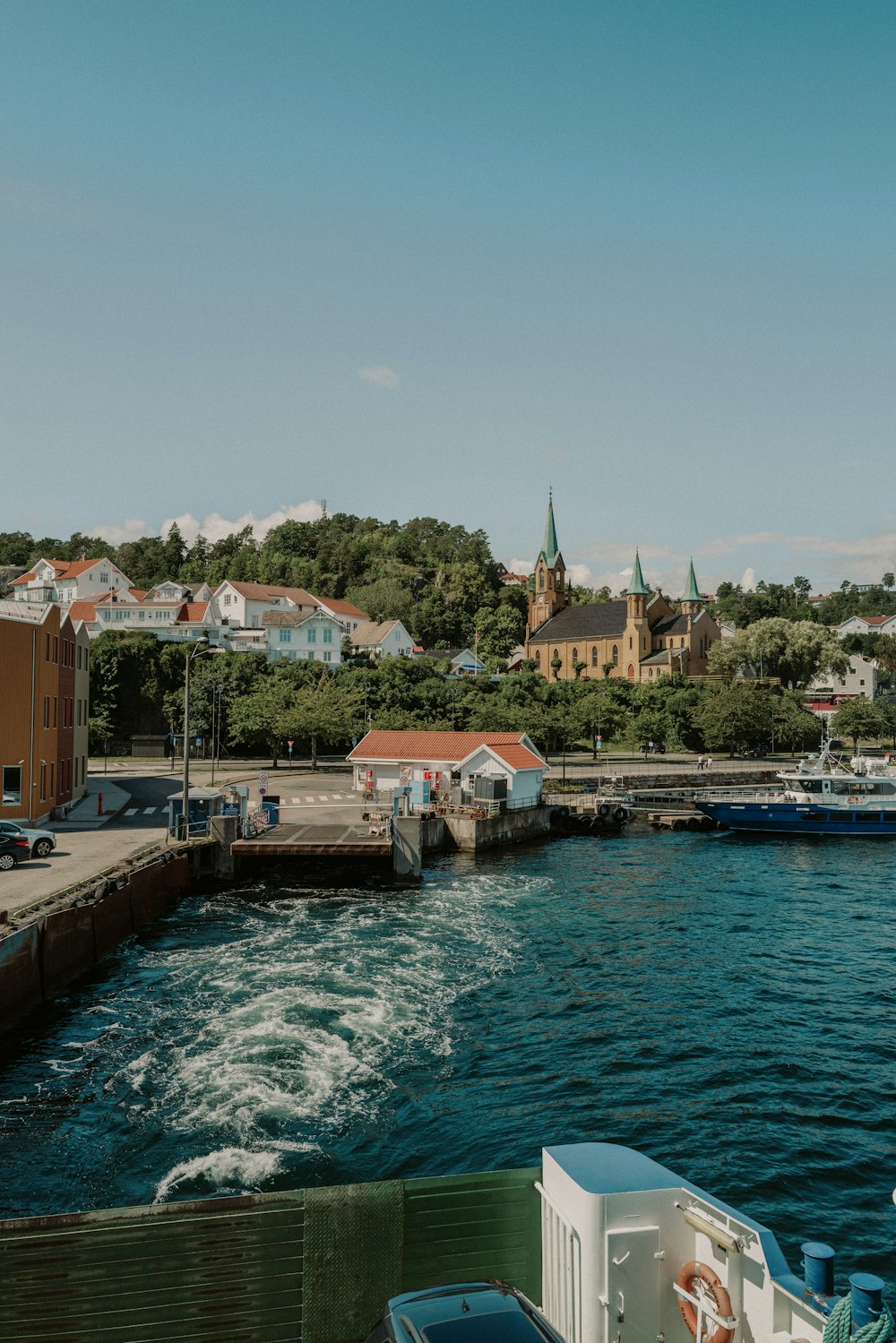 a boat traveling down a river next to a city