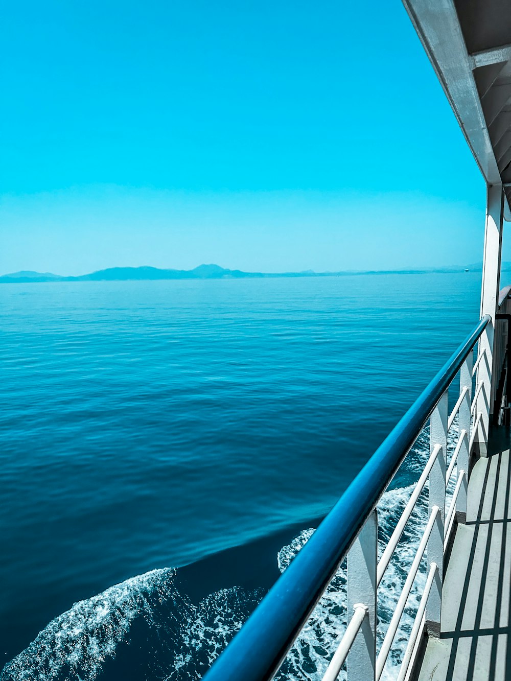 a man sitting on a boat looking out at the ocean