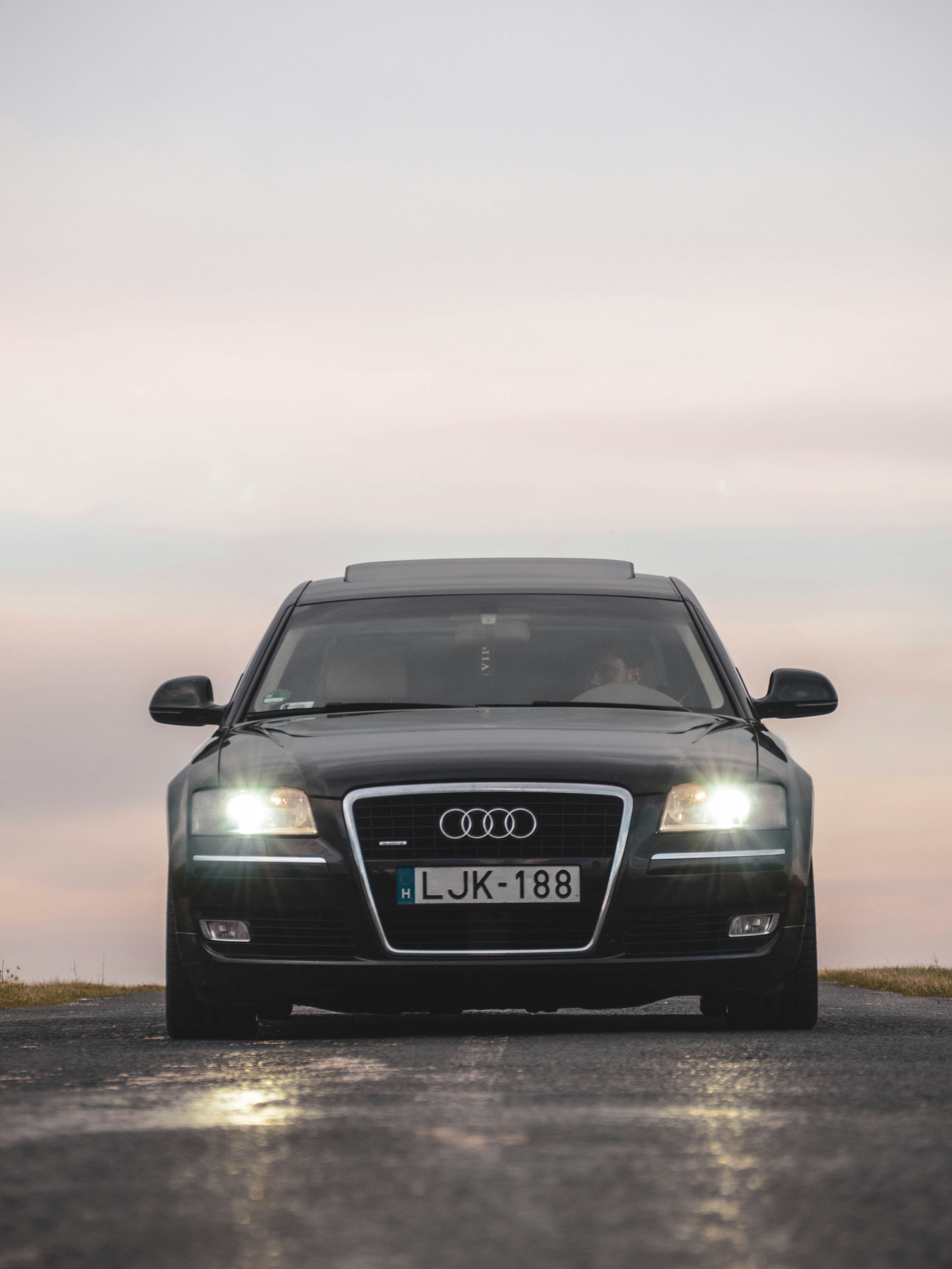 a black car parked on the side of a road