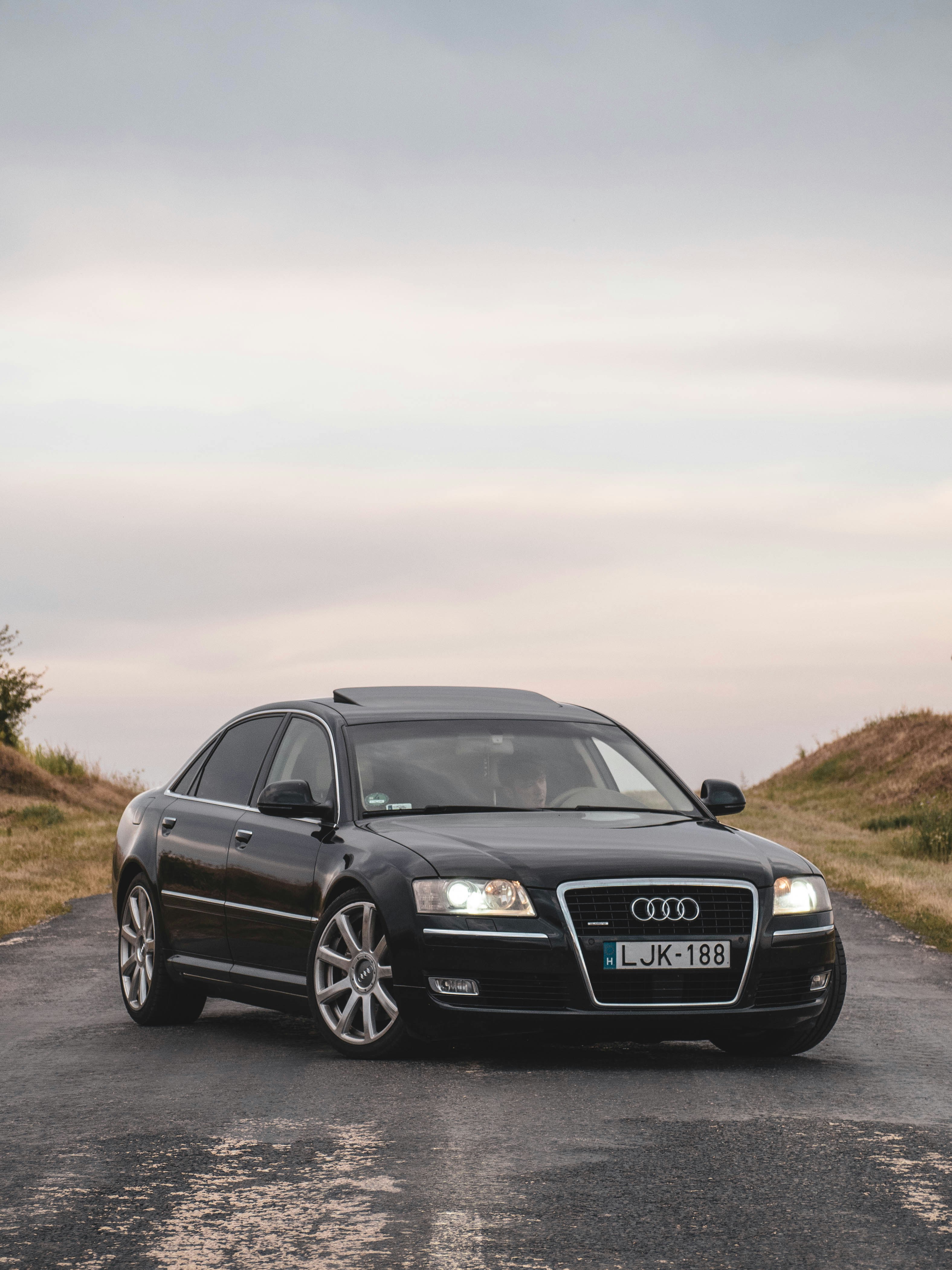a black car parked on the side of a road