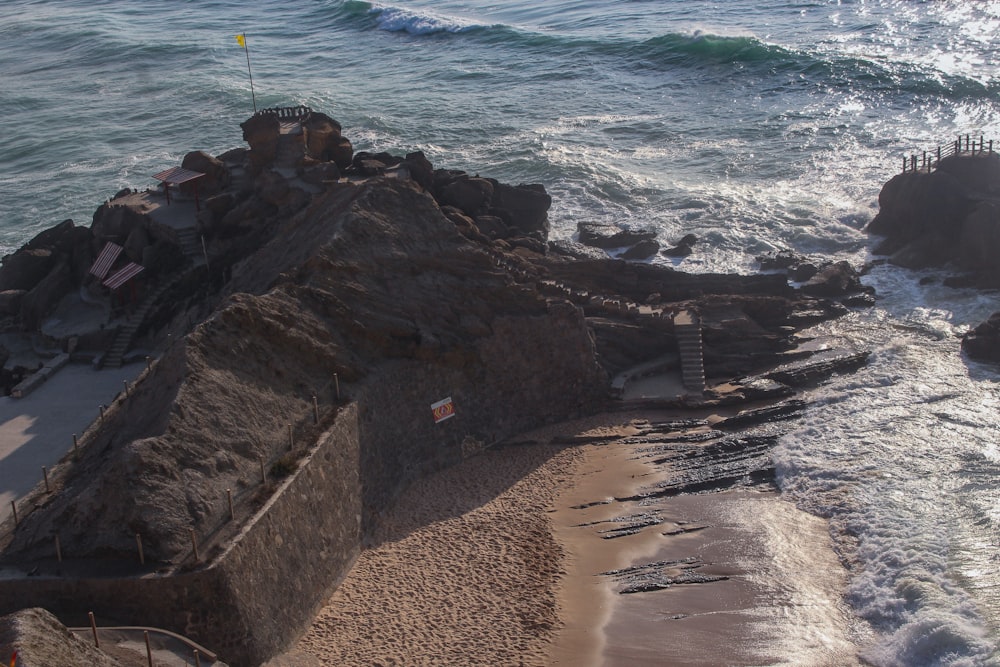 an aerial view of a beach with waves coming in