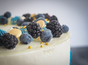 Close-up of a beautifully decorated cake with fresh berries and delicate icing.