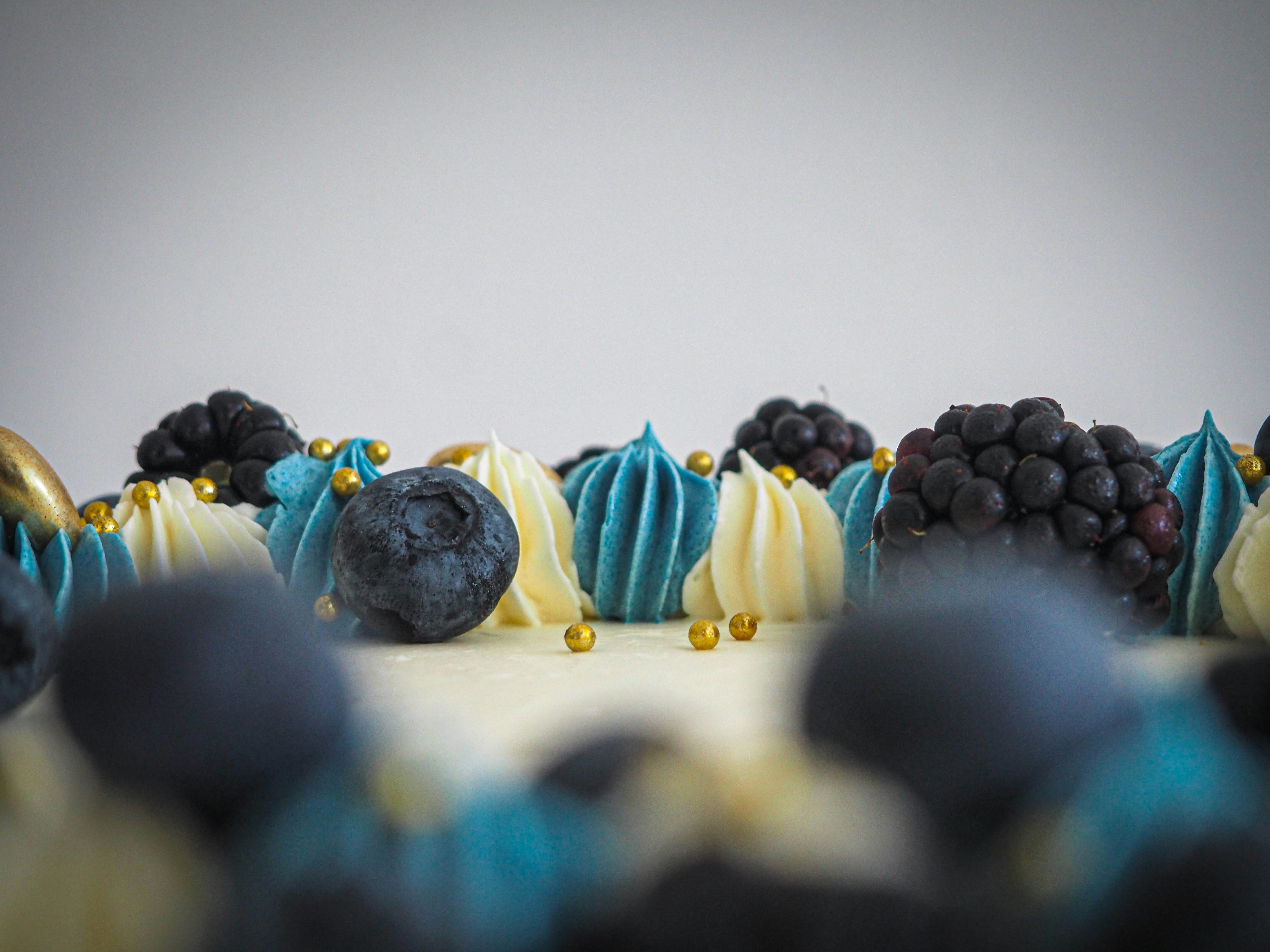 a close up of a cake with blue and white frosting
