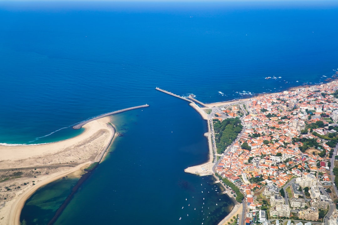 an aerial view of a city next to the ocean,
