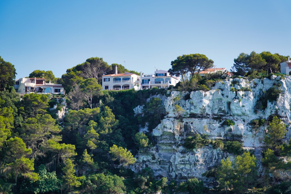 a house on top of a cliff surrounded by trees