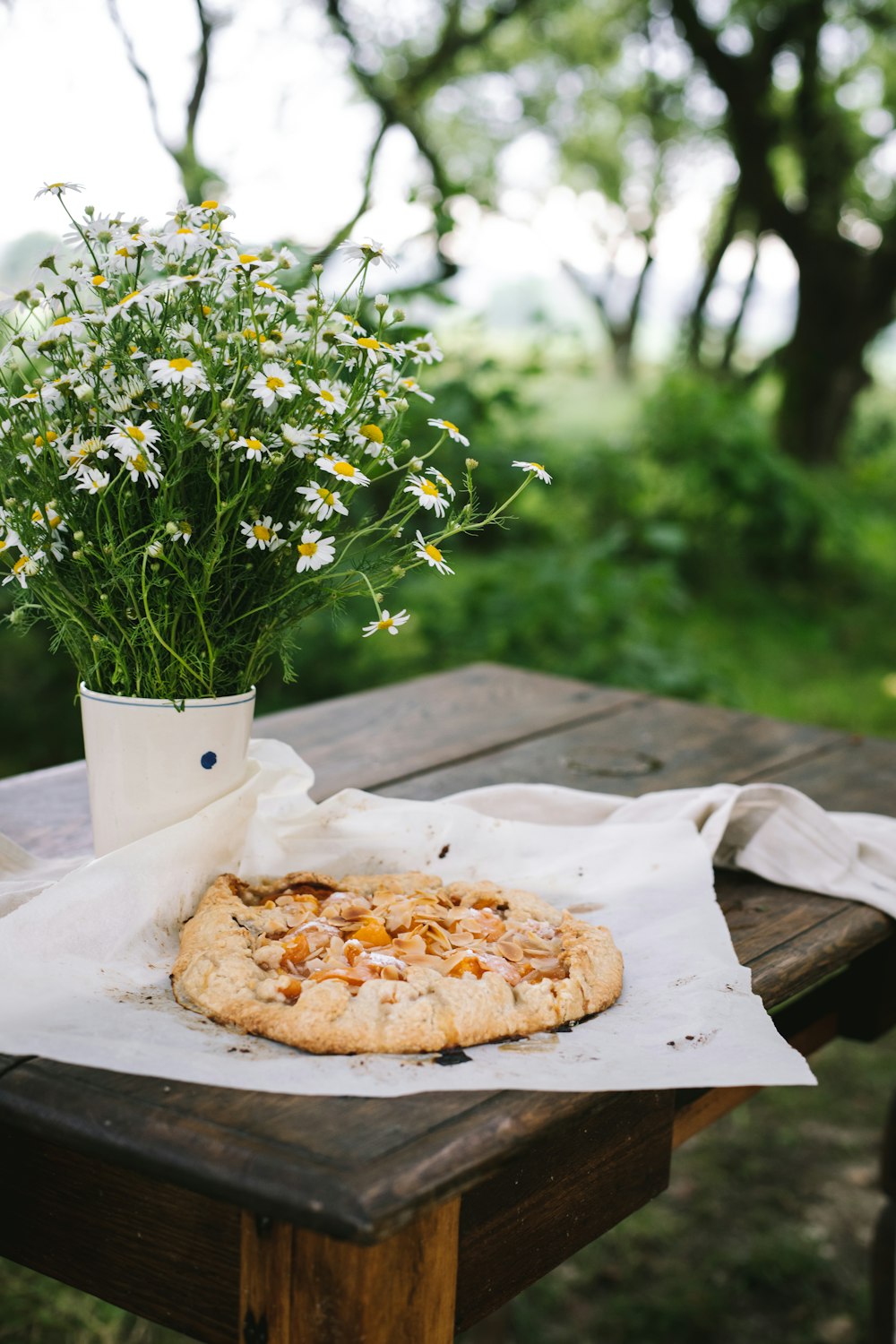 a pizza sitting on top of a wooden table