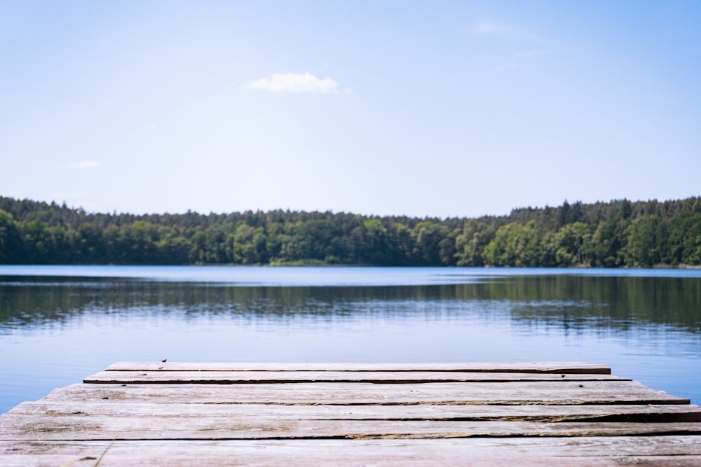 a wooden dock sitting on top of a lake