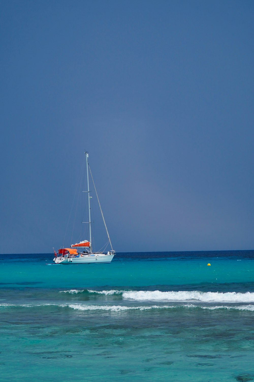 a sailboat in the middle of the ocean