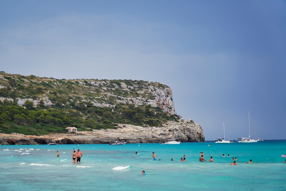 a group of people swimming in the ocean