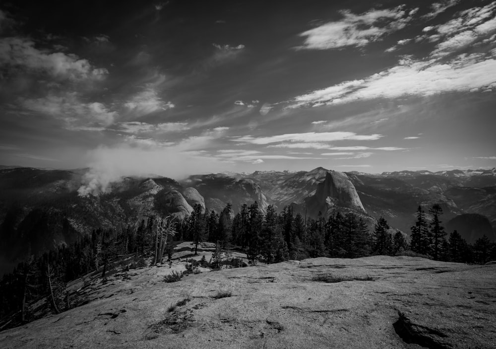 a black and white photo of mountains and trees