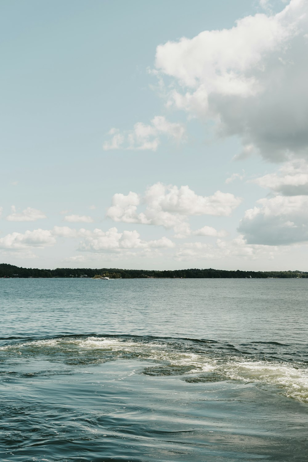 a body of water with a boat in the distance