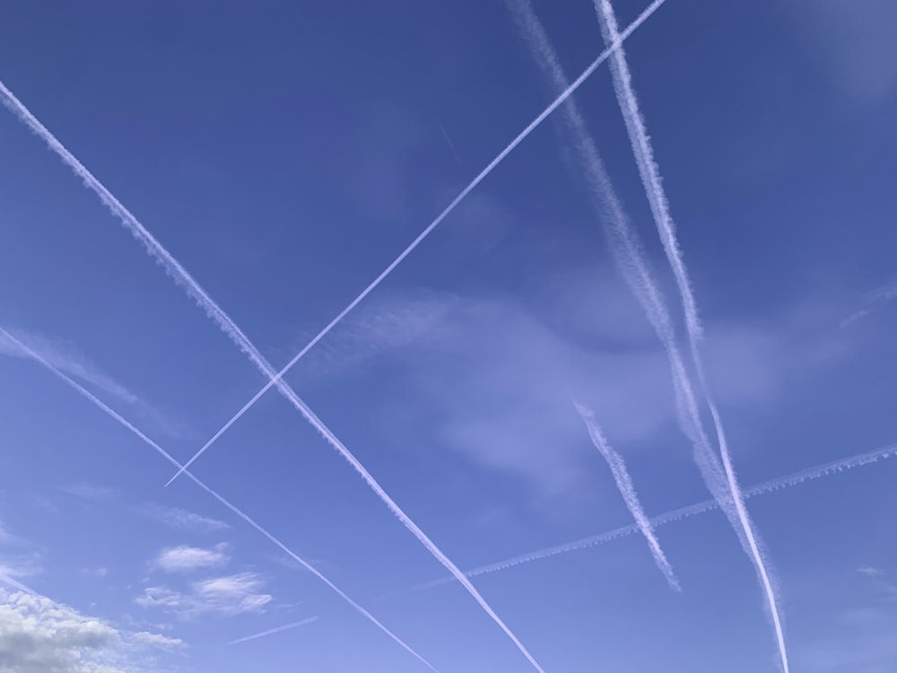 a group of airplanes flying through a blue sky