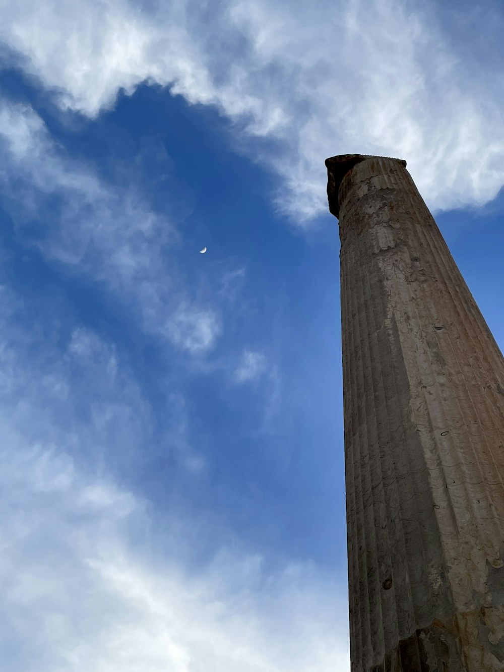 a tall pillar with a sky in the background