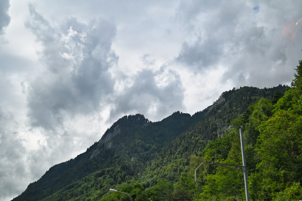 a view of a mountain with a cloudy sky