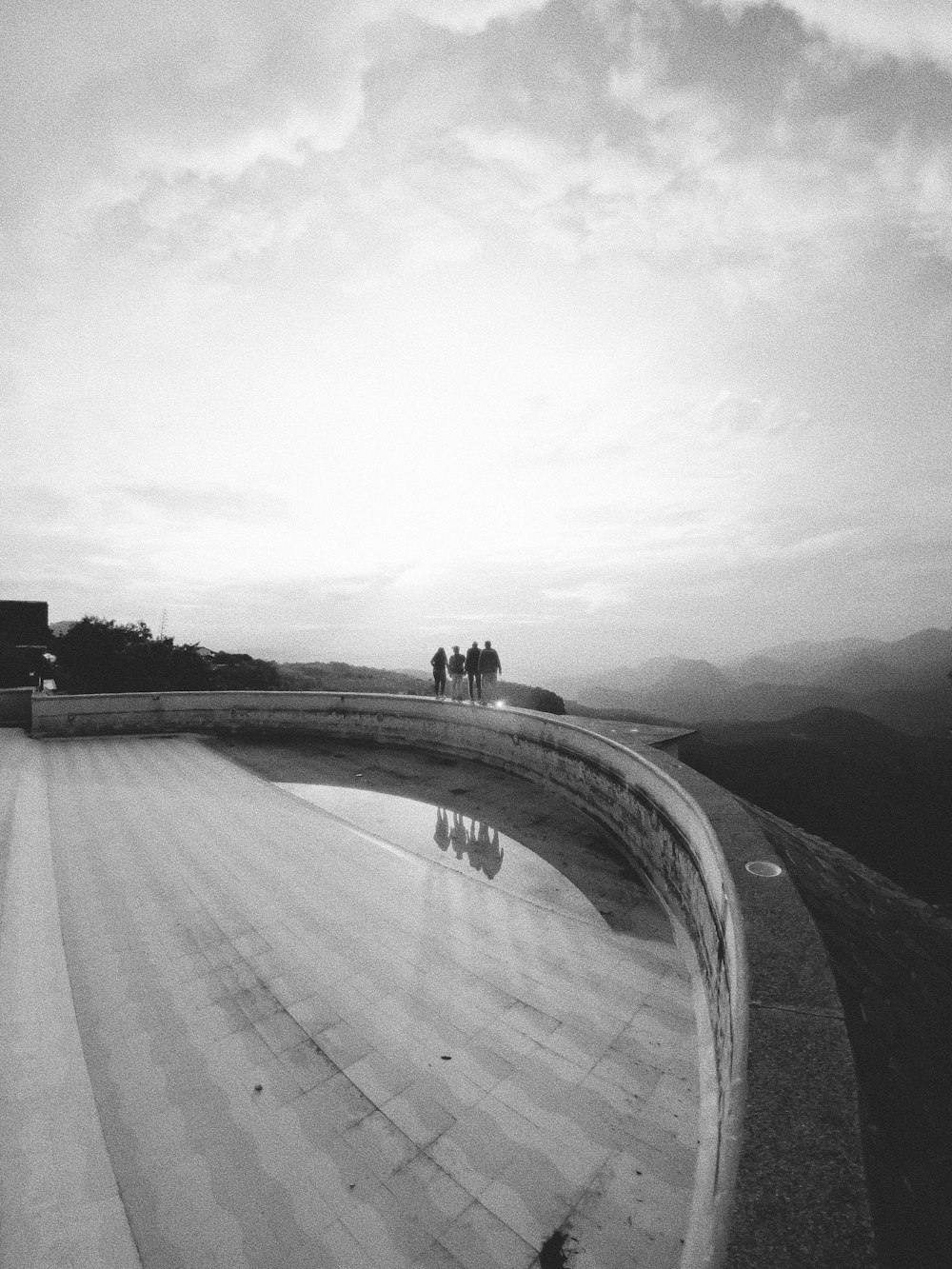 a black and white photo of a skateboarder doing a trick