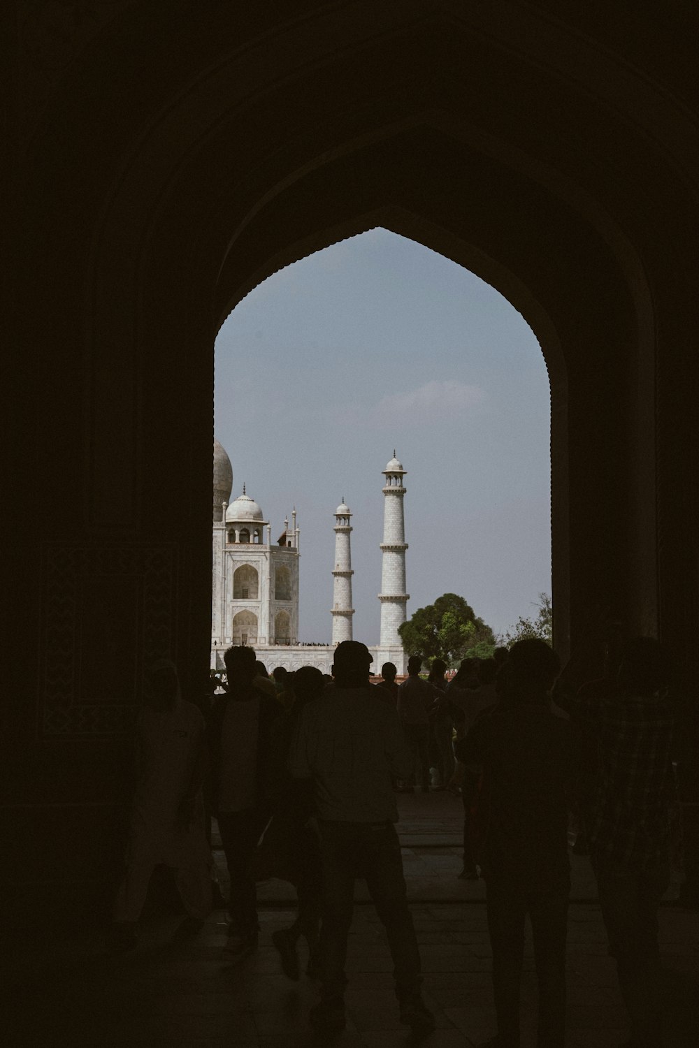 a group of people standing under an archway