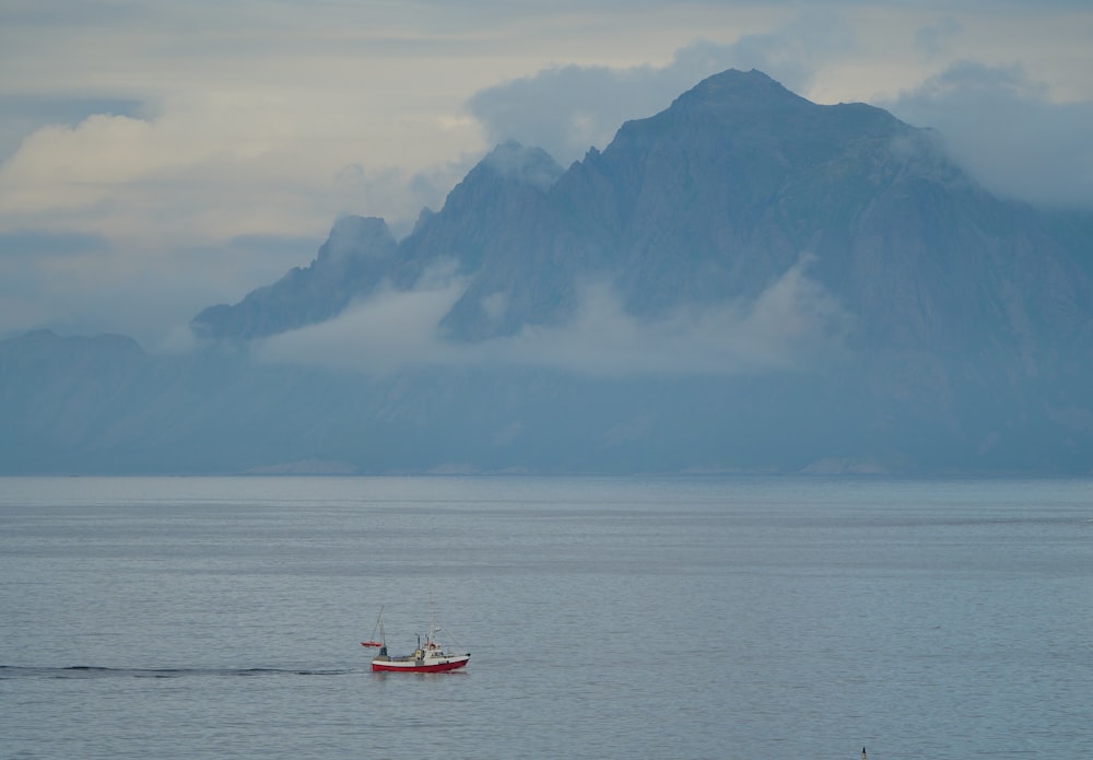 a small boat in the middle of a large body of water