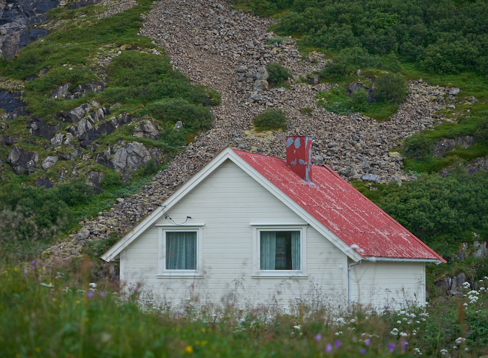 a small white house with a red roof