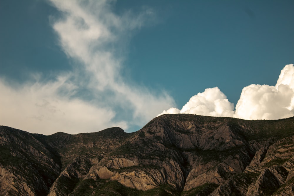 a view of a mountain range with clouds in the sky