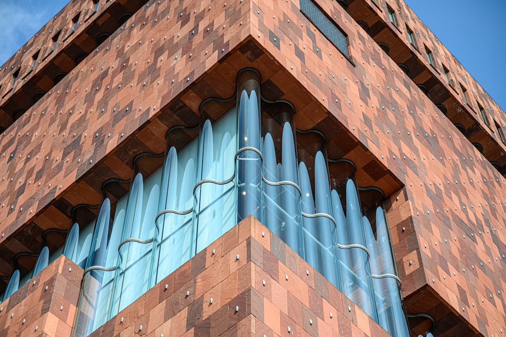 a tall brick building with a blue sky in the background