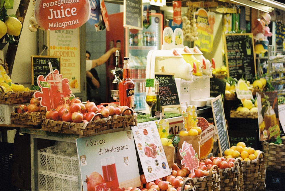 a fruit stand with apples and oranges for sale