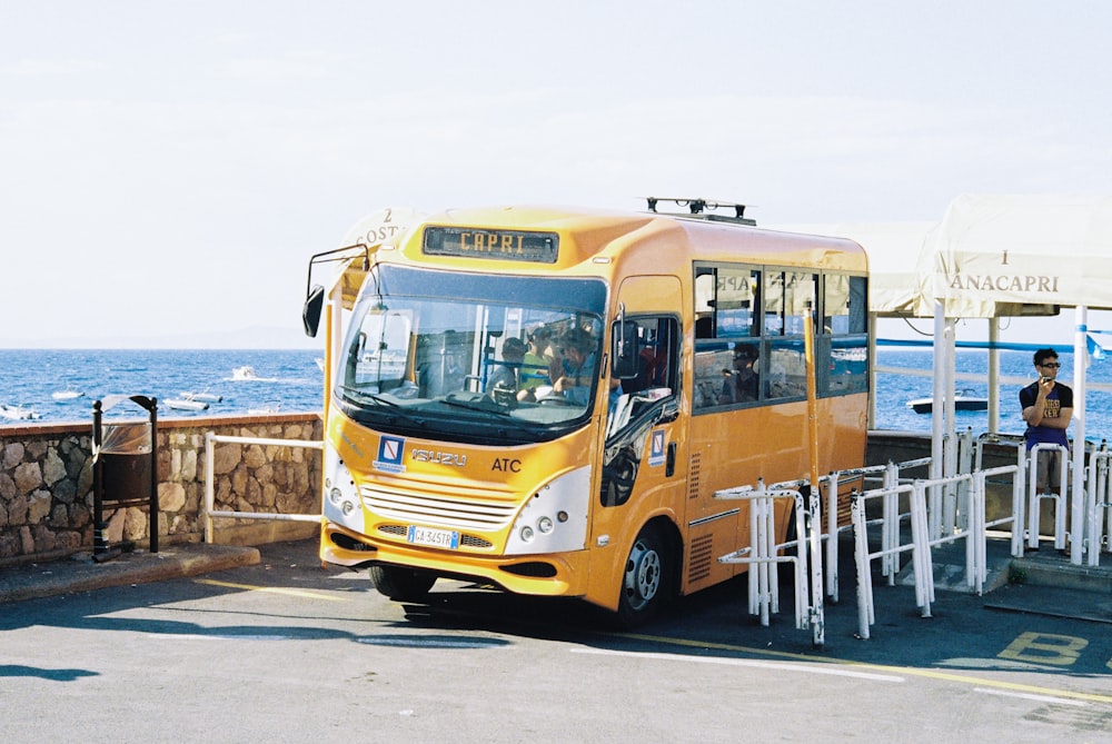 a yellow bus parked on the side of the road