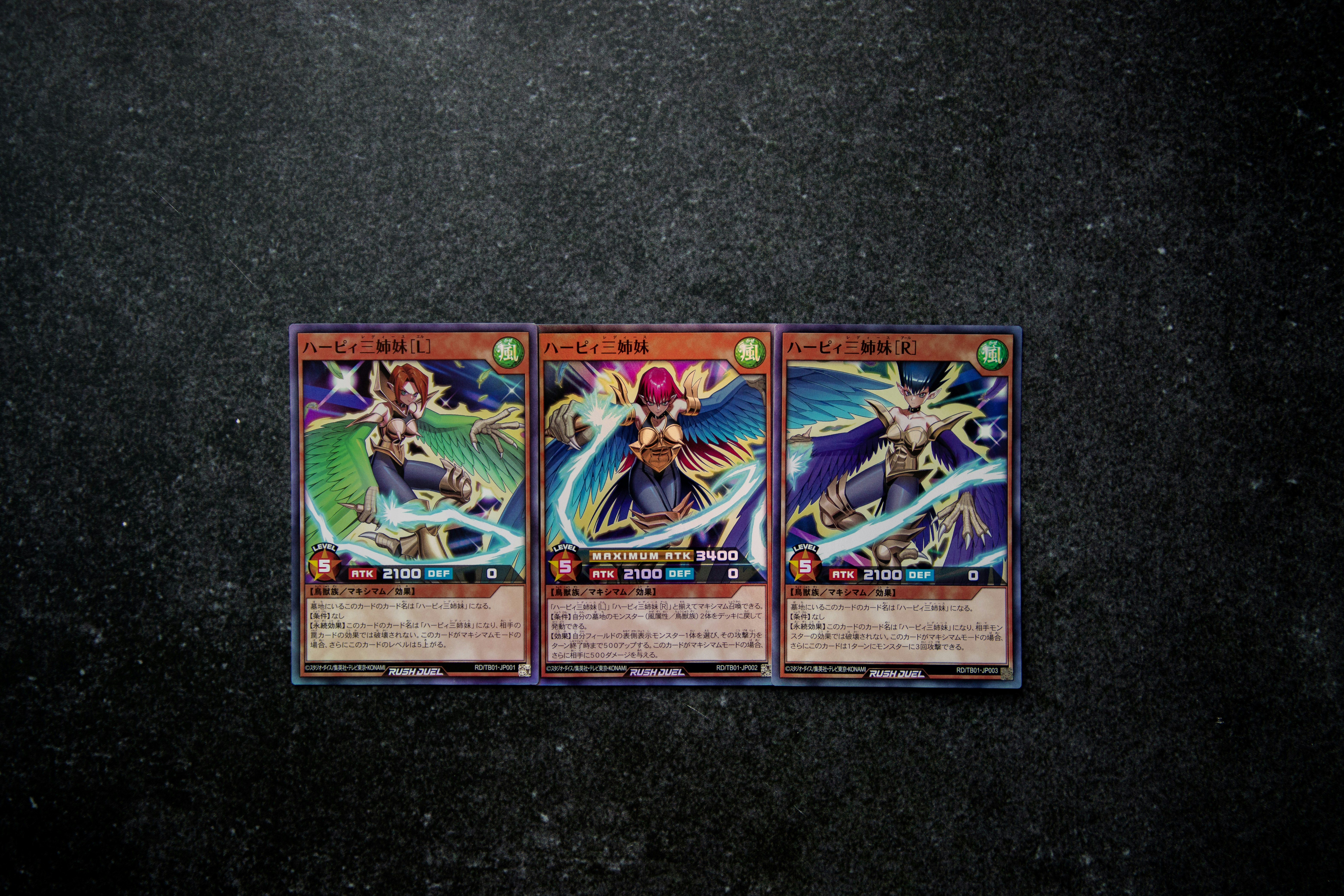 three cards of the same type on a black surface